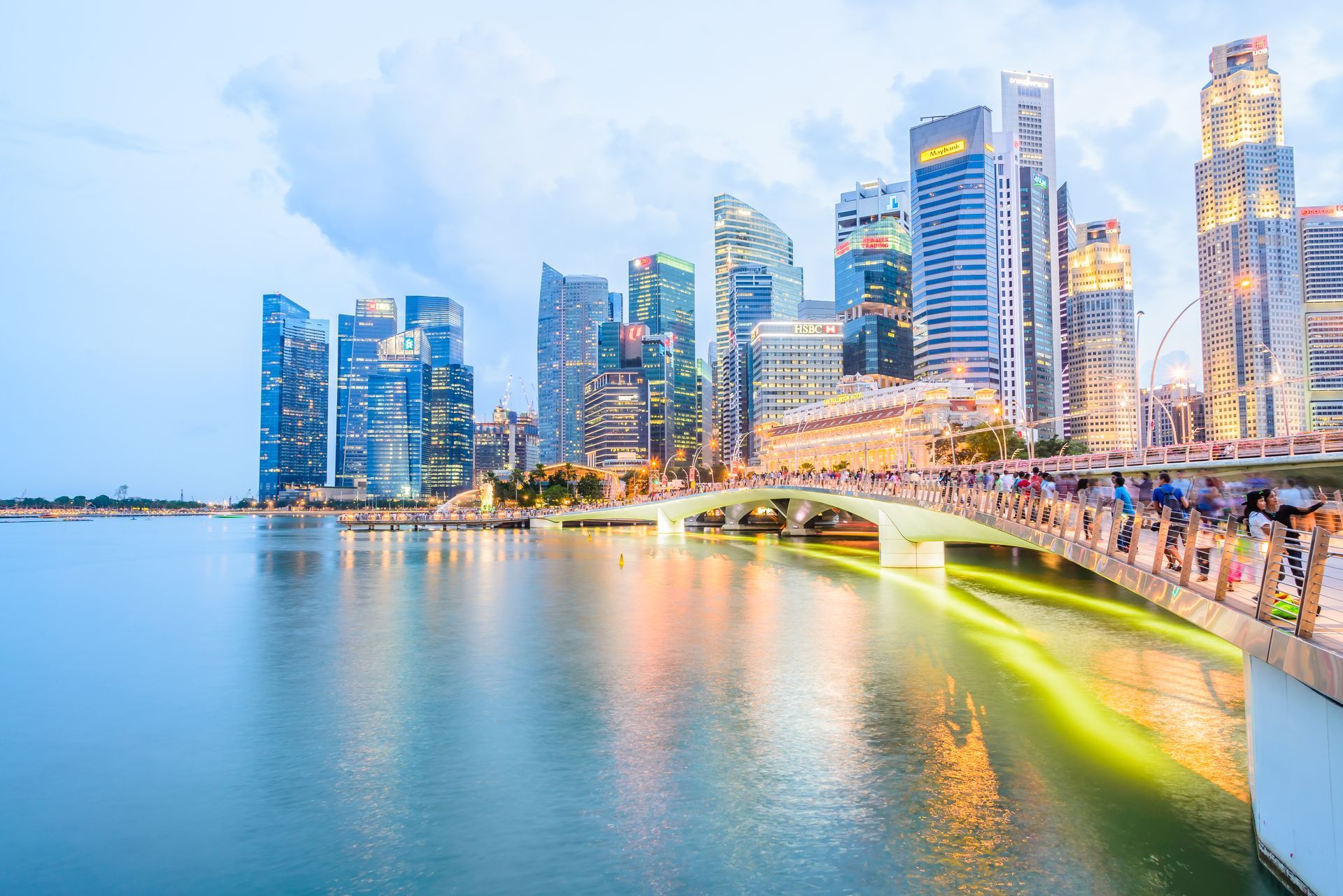 Futuristic pedestrian bridge in Singapore with city skyline