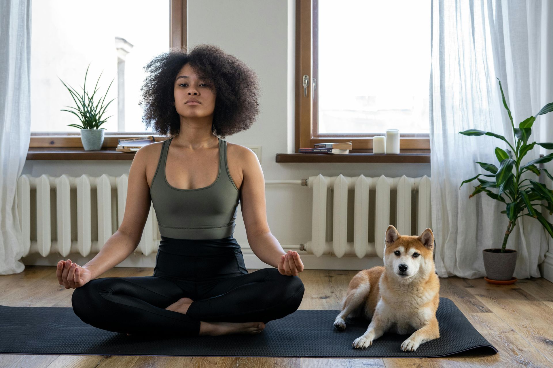 A curly haired woman practices yoga for divorce.