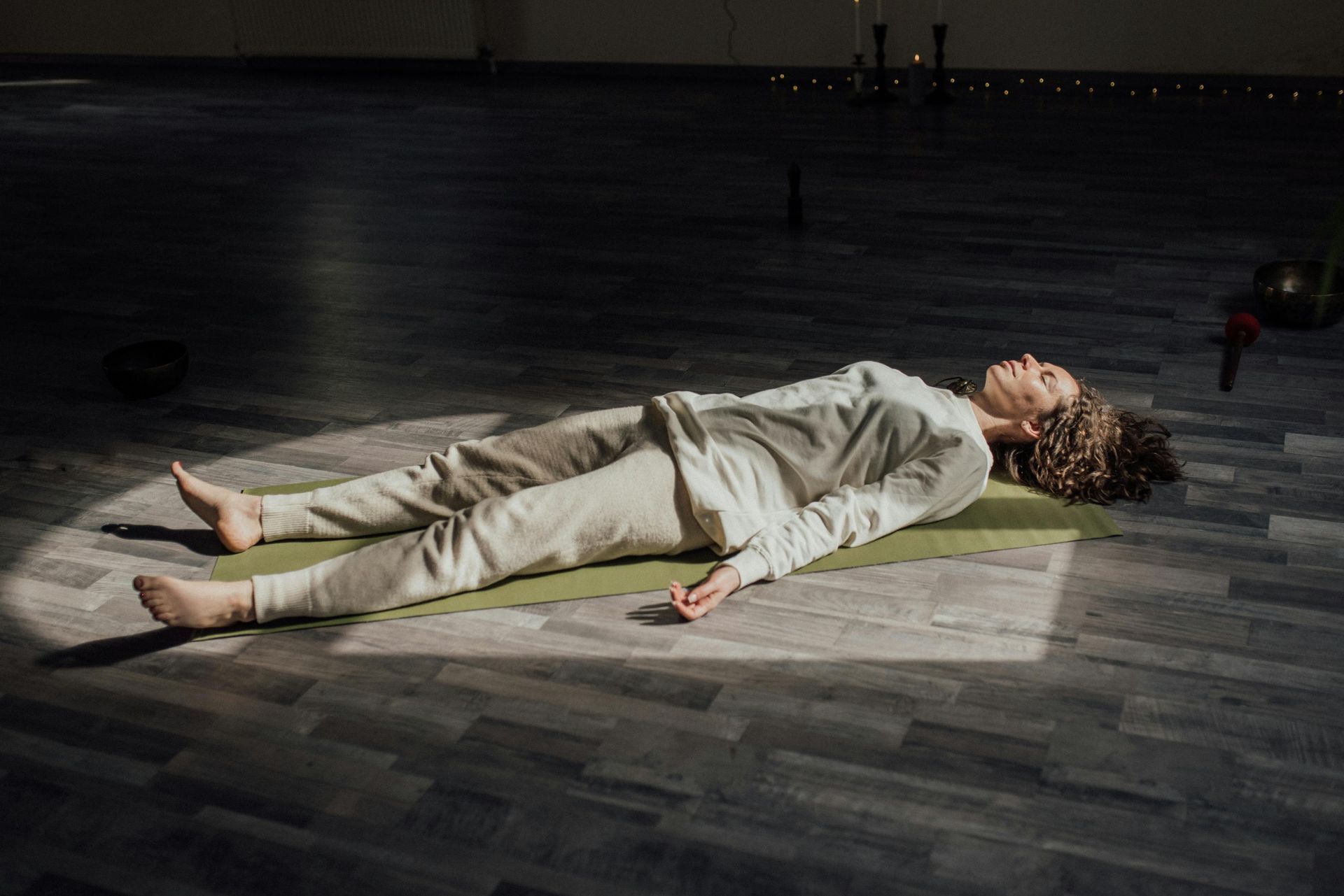 Relaxed woman practices corpse pose yoga for divorce.