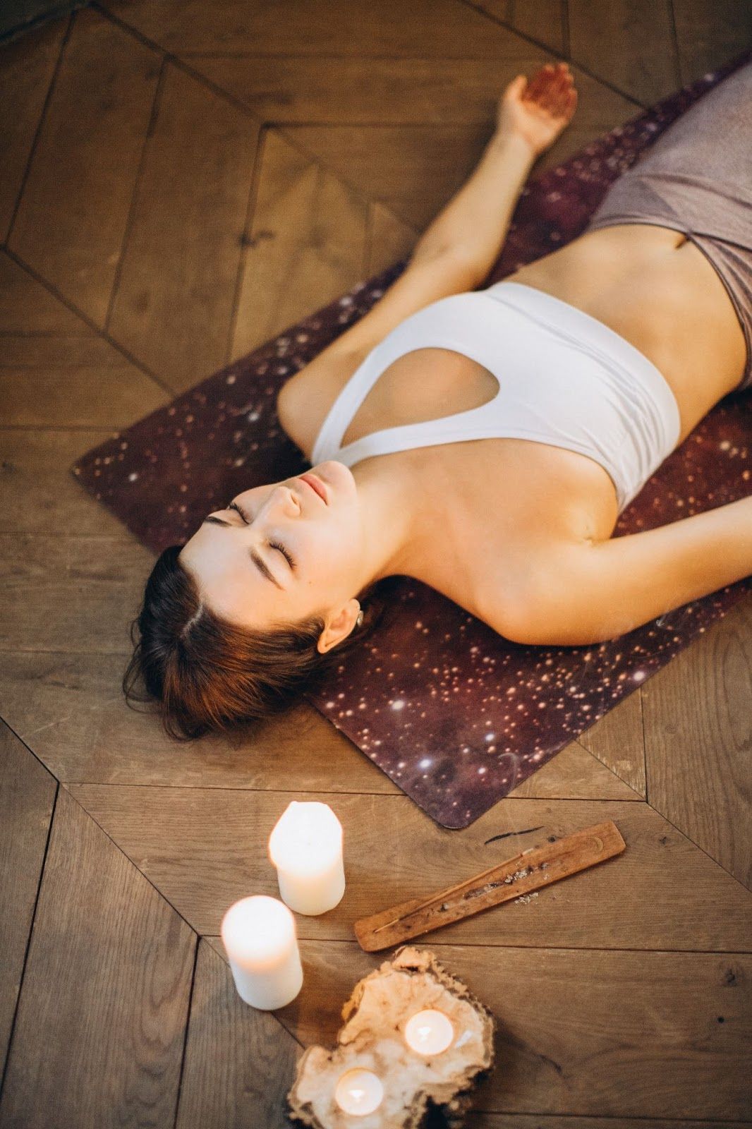 Relaxed woman practices corpse pose yoga for divorce.