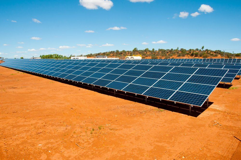A Row of Solar Panels Sitting on Top of A Dirt Field — RC Civil in Armidale, NSW