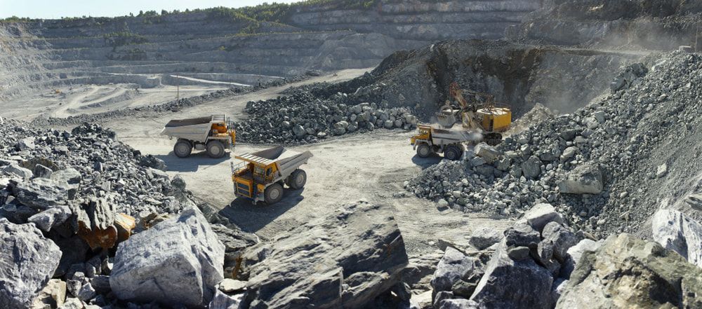 A Group of Trucks Are Driving Through a Rocky Area — RC Civil in Armidale, NSW