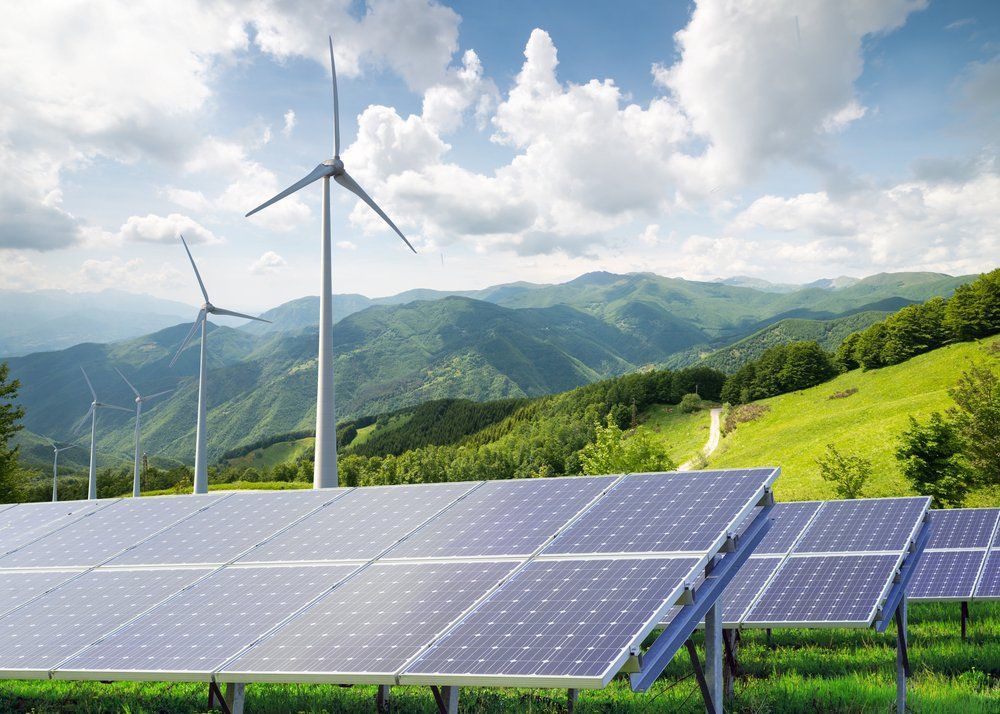 A Field of Solar Panels and Wind Turbines with Mountains in The Background — RC Civil in Armidale, NSW