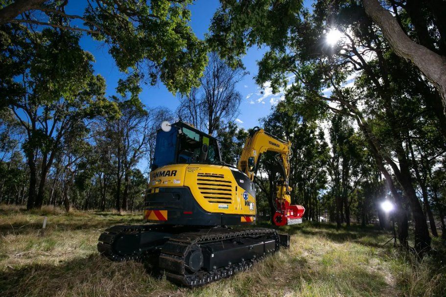 A Yellow and Black Excavator Is Parked in The Middle of A Forest — RC Civil in Armidale, NSW