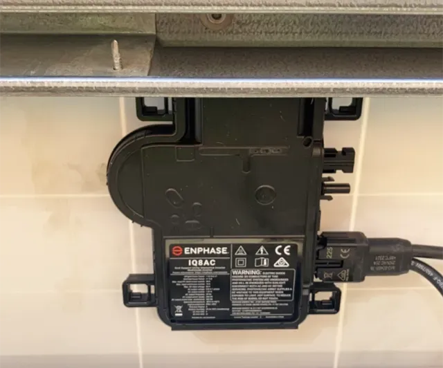 A Black Solar Converter on a Garage Wall — Todd Basham Electrical in Cootamundra, NSW