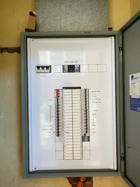 Open electrical panel on a wall. Inside are circuit breakers, wiring, and a diagram. — Todd Basham Electrical in Cootamundra, NSW