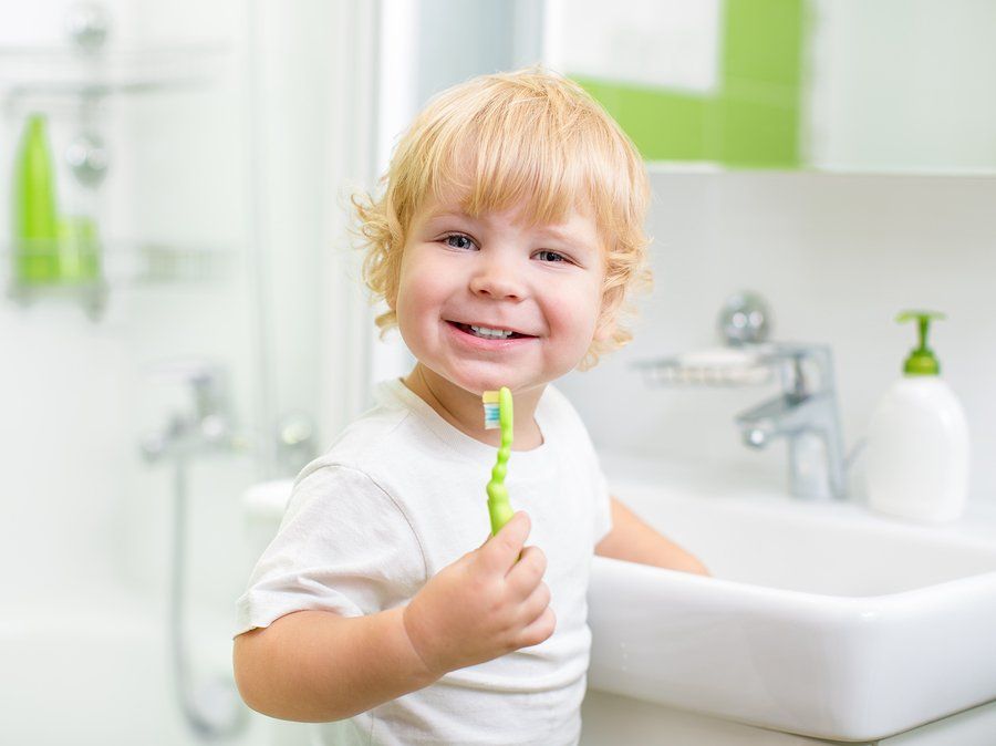 Smiling Kid brushing teeth