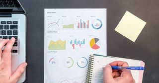 A piece of paper with several graphs and other statistical information on a desk, to illustrate data.