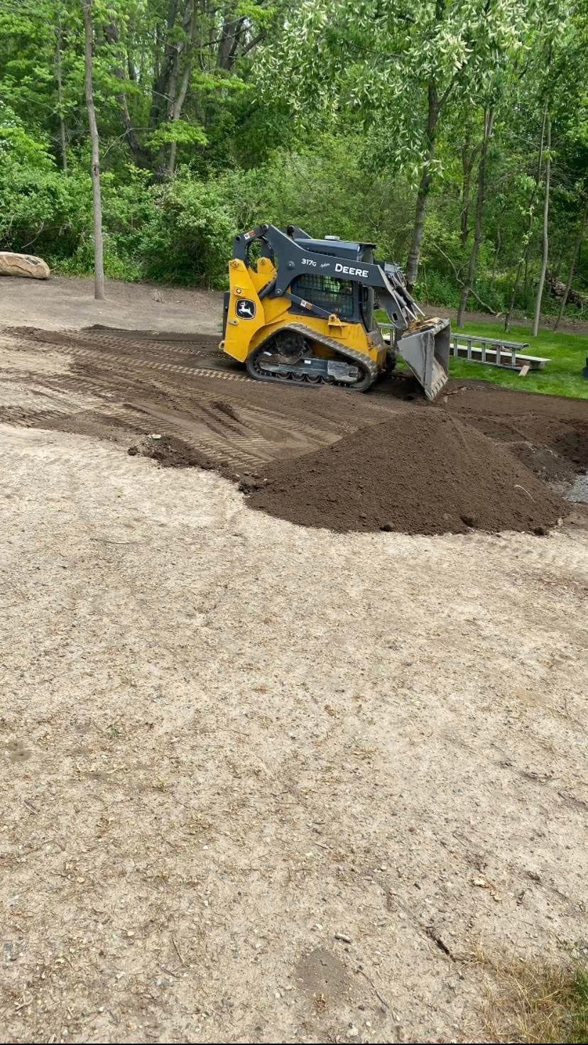A bulldozer is moving dirt in a dirt field.