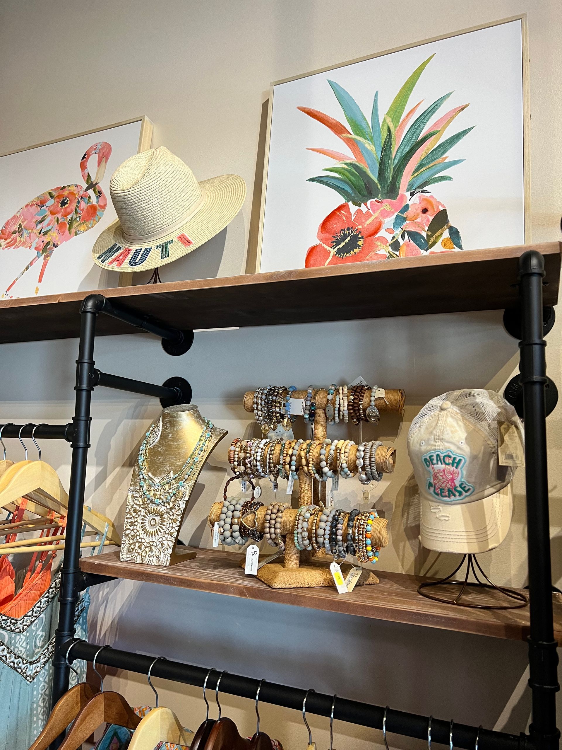A display of hats and bracelets on a shelf in a store.