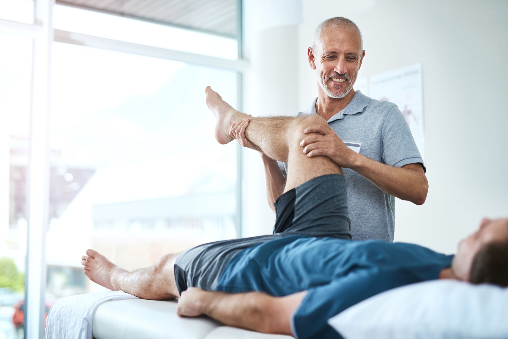 a man is getting a knee massage from a physical therapist