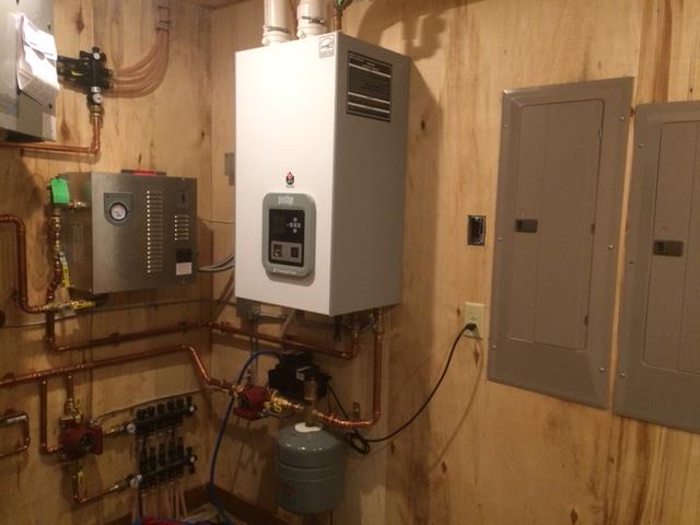 A generator is sitting on the side of a building - Electrical Repairs in Cook, MN A generator is sitting on the side of a building - Electrical Repairs in Cook, MN