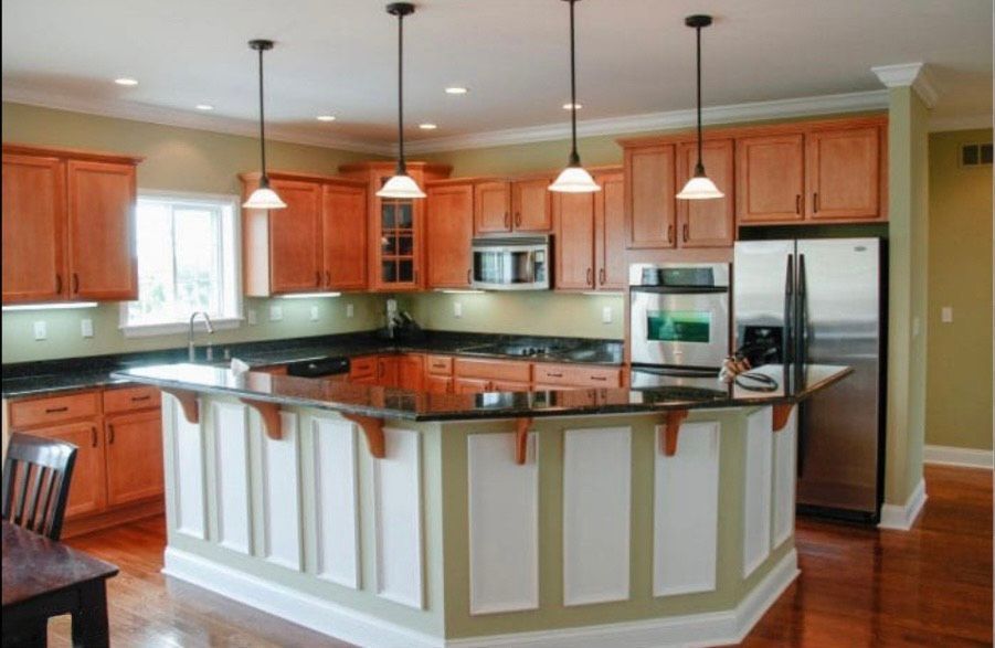 A kitchen with stainless steel appliances and wooden cabinets