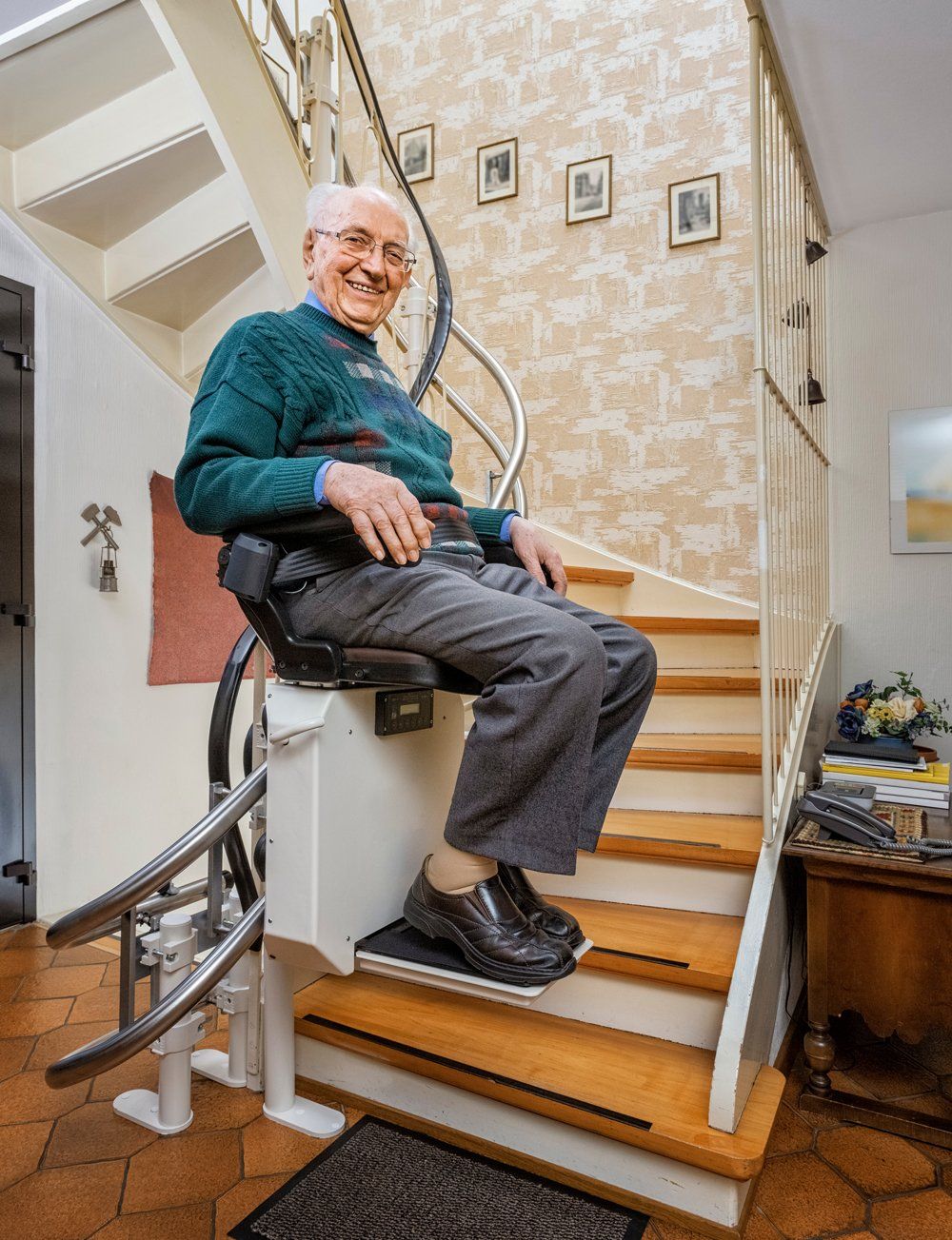 A Happy Old Man Sitting on a Stair Lift
