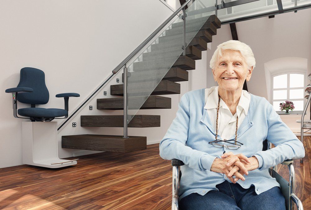 A Happy Old Woman With Stair Lift Behind Her