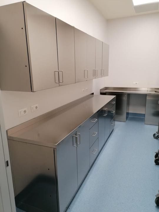 Una cucina con mobili in acciaio inox e pavimento blu