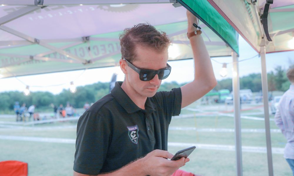 Candid photo of Chris Degenaars looking down at his phone