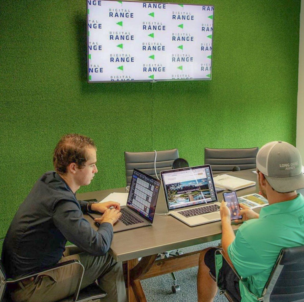 Chris Degenaars and Blake Davis at the Long Drive Agency office working on their laptops