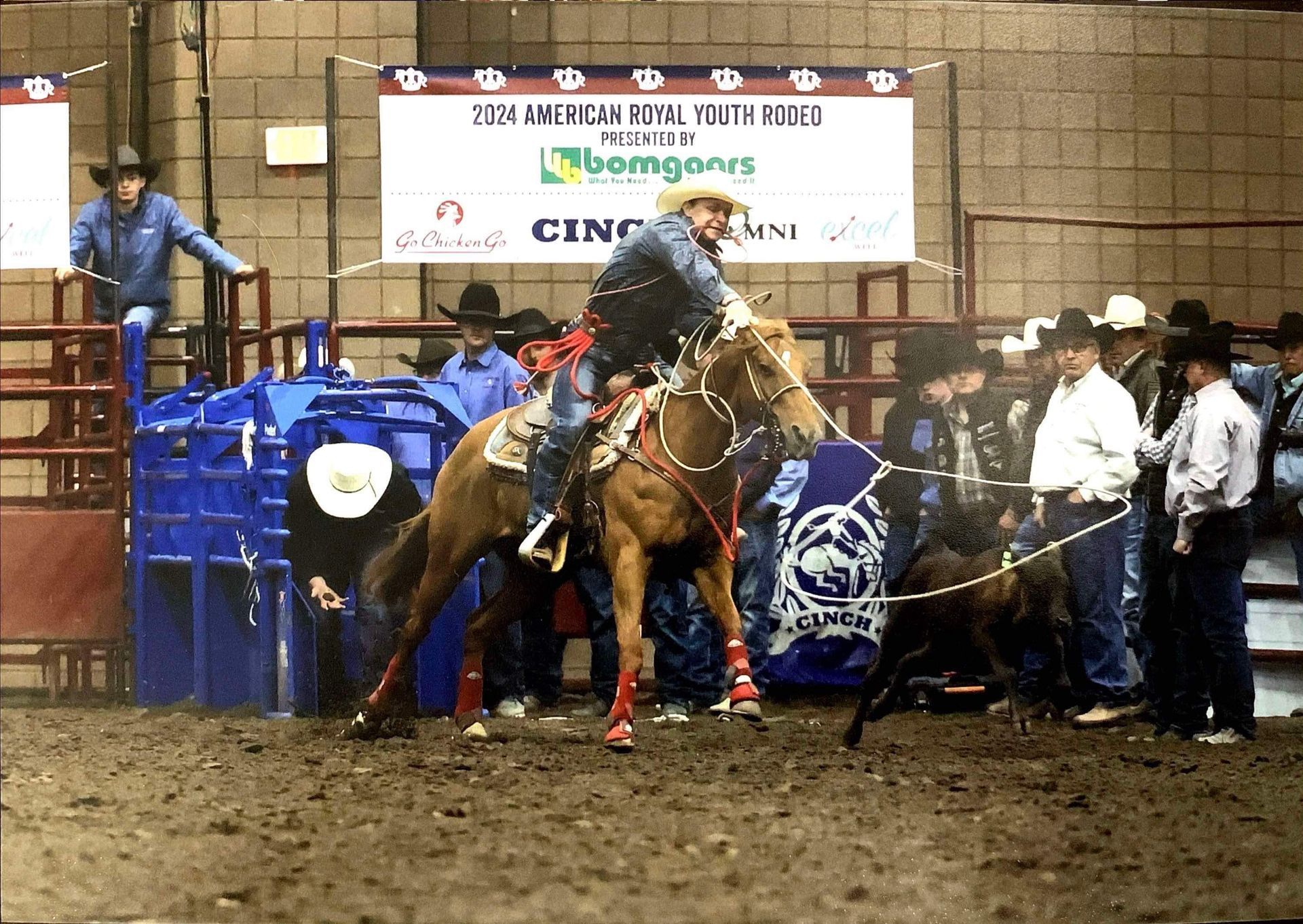 A man is riding a horse in front of a banner that says cincinnati