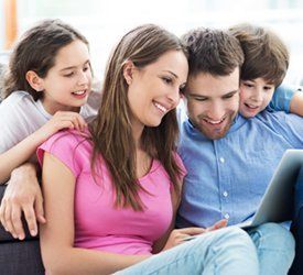 family smiling laptop