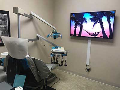 Dental Implants — Dental Clinic With Flat Screen In North Hills, CA