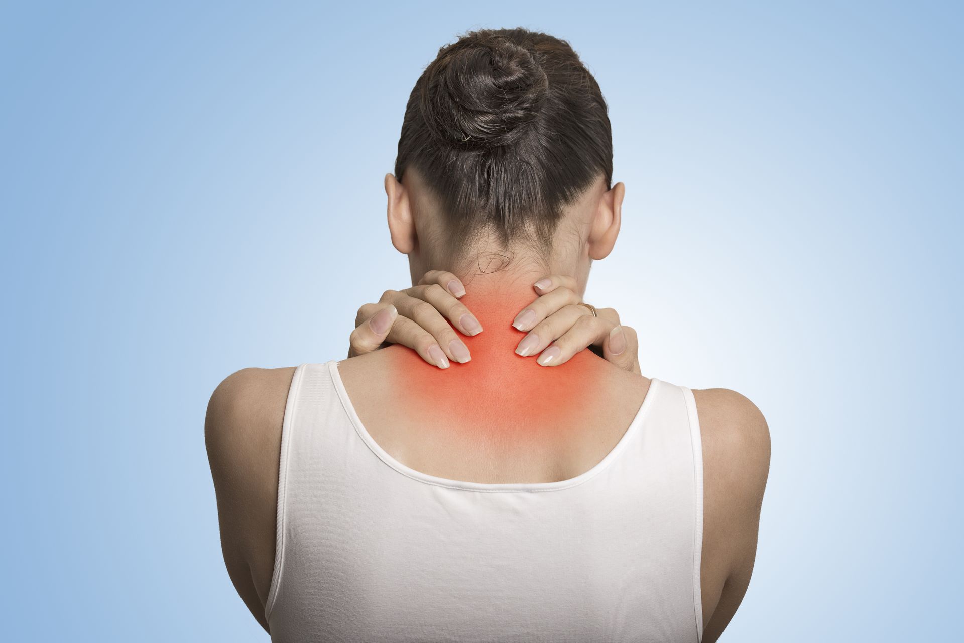 A woman is holding her neck in pain and has a red spot on her neck.