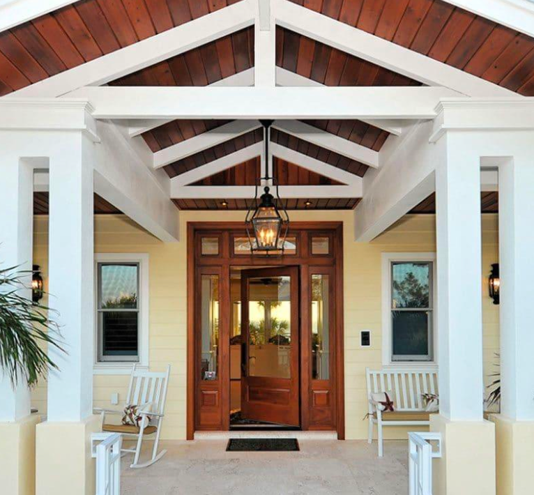Wooden rafters forming the ceiling of a room, angled up towards the viewer.