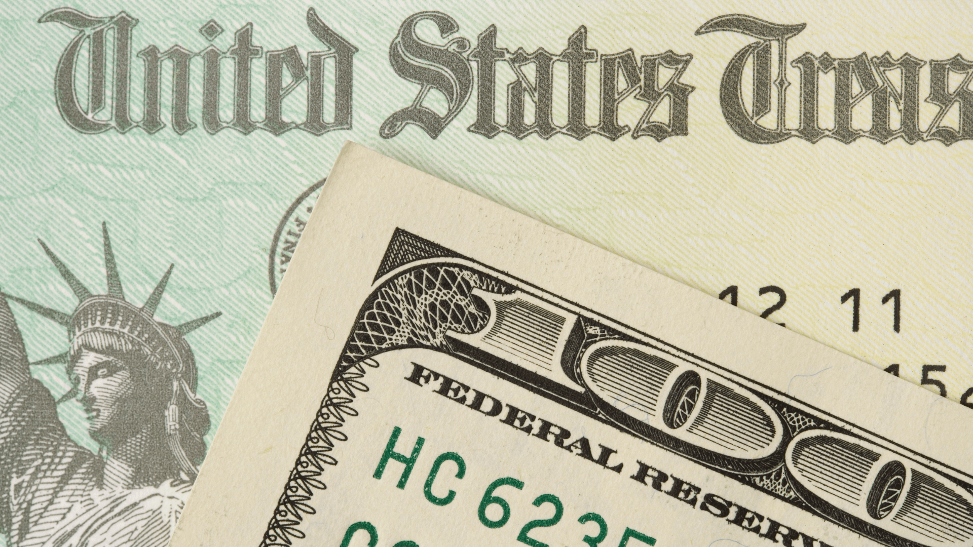 US Treasury Check behind a hundred dollar bill.