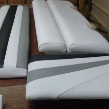 Boat cushions in white, black, and gray; arranged indoors.
