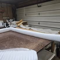 White rolled material on a wooden table in a garage.