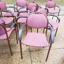 Pink chairs arranged outdoors.