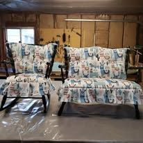 Two patterned armchairs in a workshop setting.