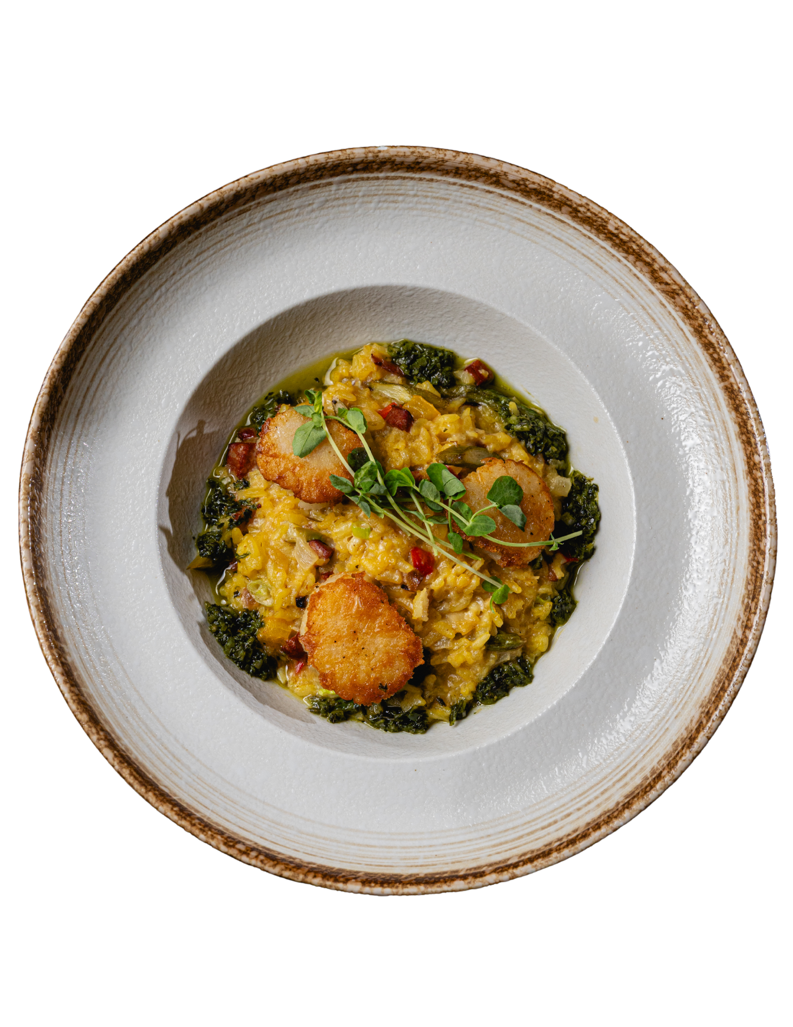 Overhead view of a plated grain bowl with roasted vegetables and greens in a white bowl