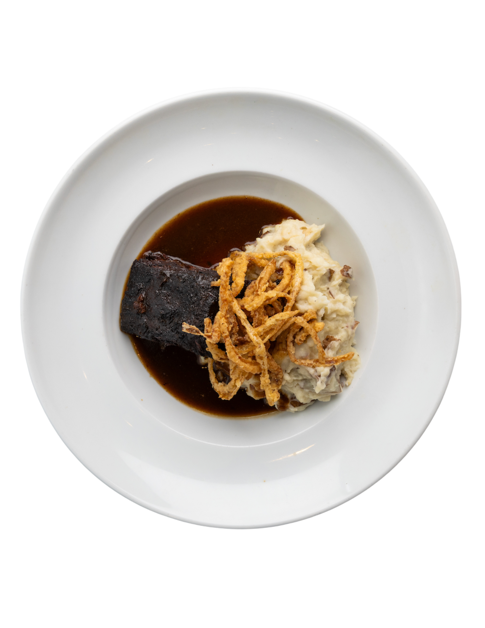 A white plate topped with a piece of meat and mashed potatoes.