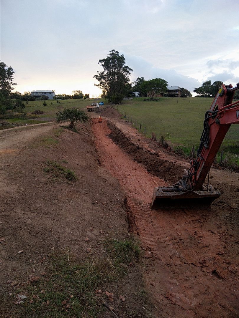 Freshly Constructed Dirt Galley With A Digger In The Right Of The Frame — Ant's Earthworks In North Deep Creek, QLD