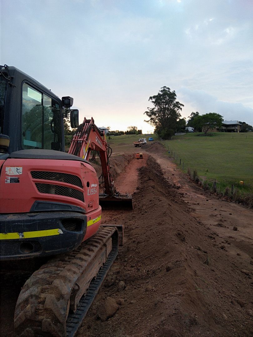 A Red Tigger Constructing a Dirt Driveway — Ant's Earthworks In North Deep Creek, QLD