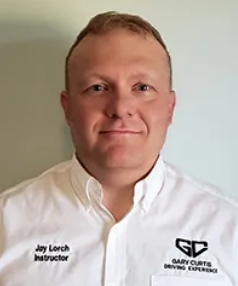 Jay Lorch, Driving Instructor, wearing a white shirt; logo on the right.