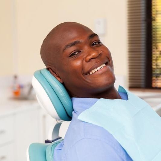person in dentist office, smiling