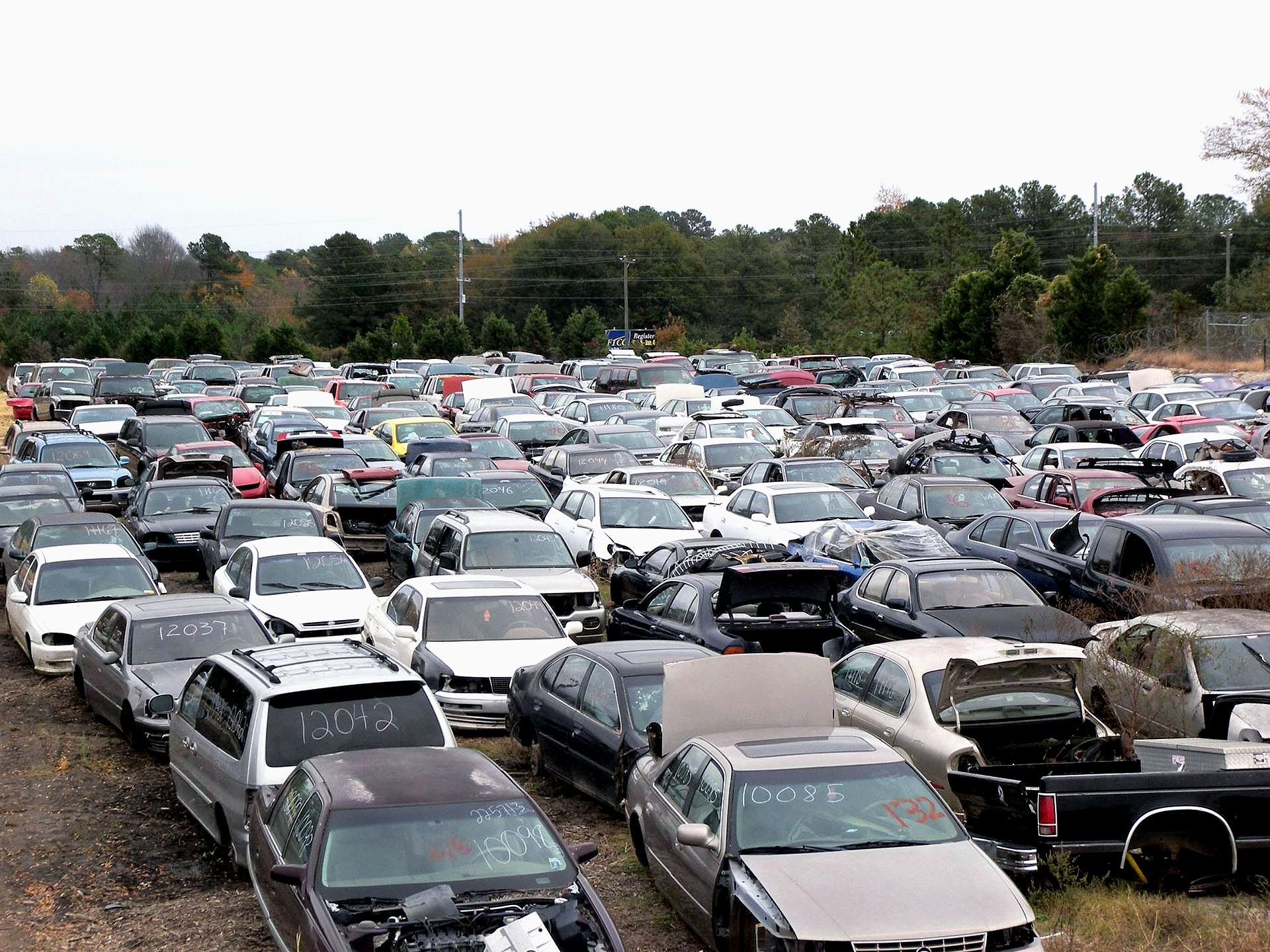 A large parking lot filled with lots of cars and trucks