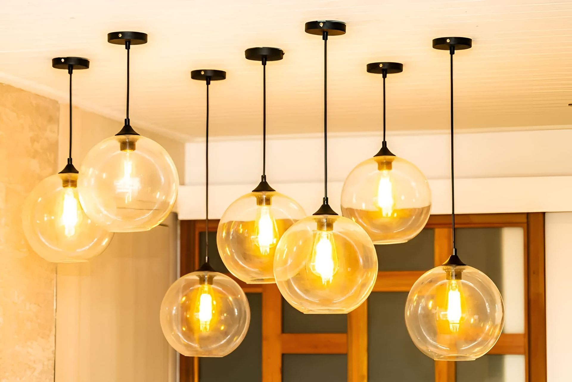 A group of pendant lights hanging from the ceiling in a room — Peter Jones Electrical In Bonny Hills, NSW