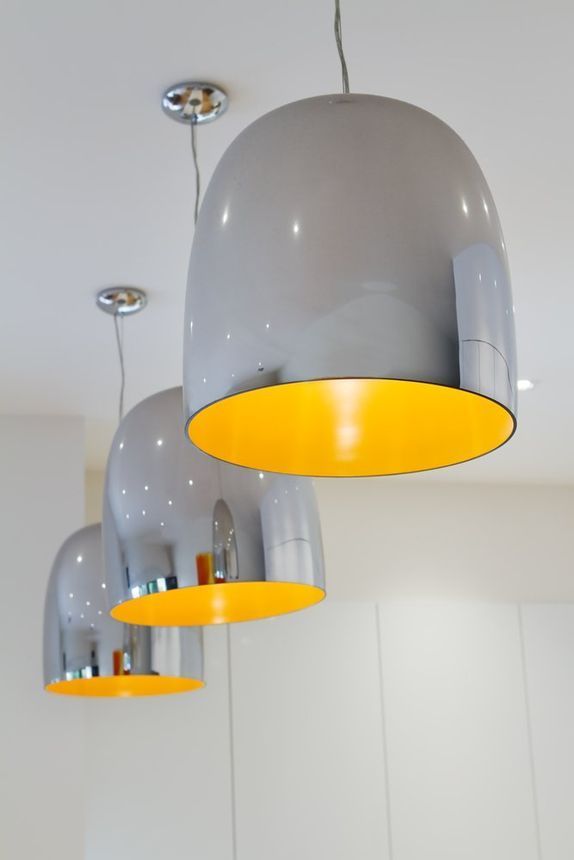 A Row Of Gray And Yellow Pendant Lights Hanging From The Ceiling — Peter Jones Electrical In Bonny Hills, NSW