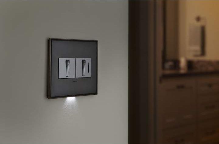 A light switch on a wall with a light on the bottom of it — Peter Jones Electrical In Bonny Hills, NSW