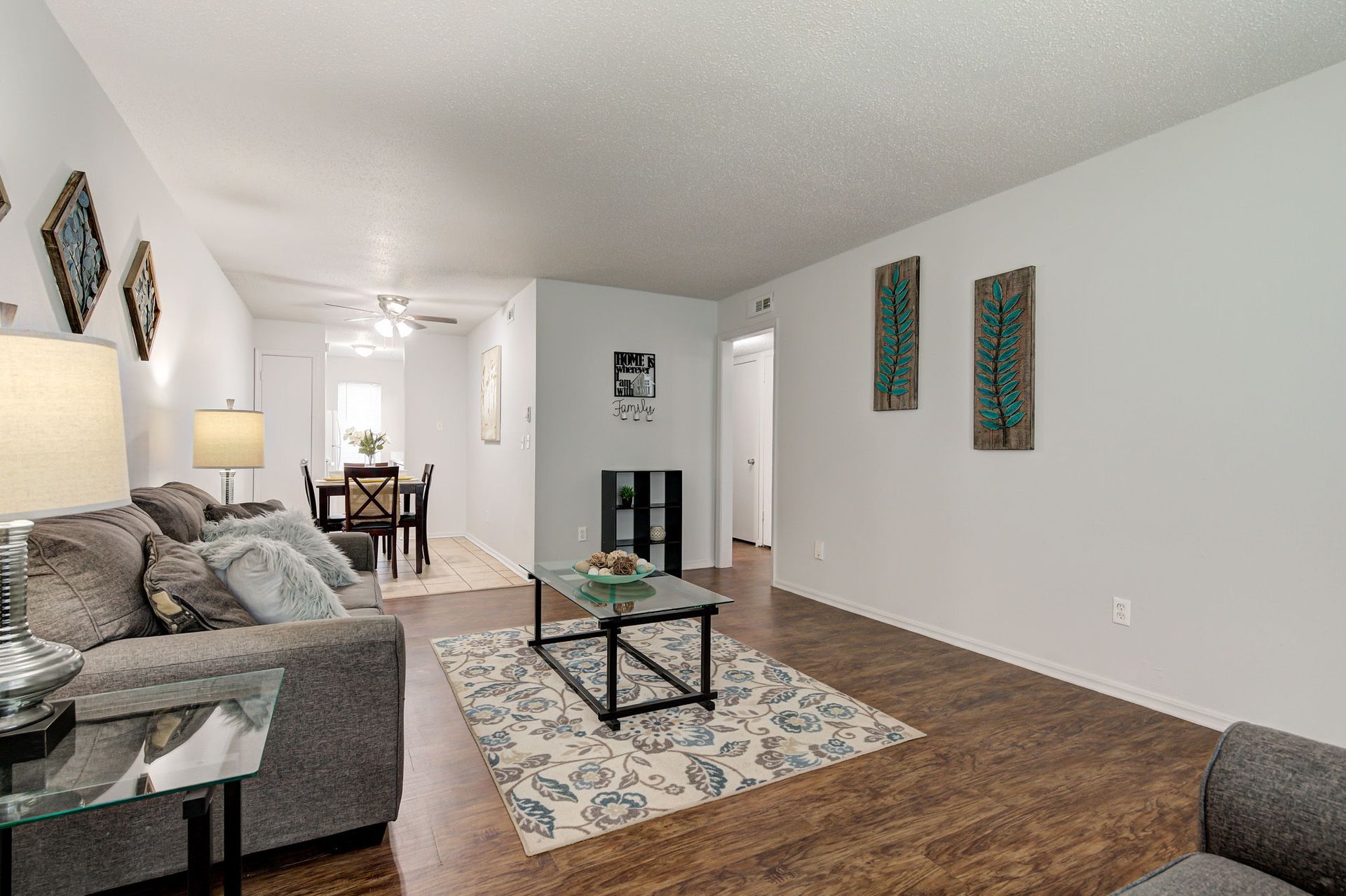 A living room with a couch , coffee table , and rug.