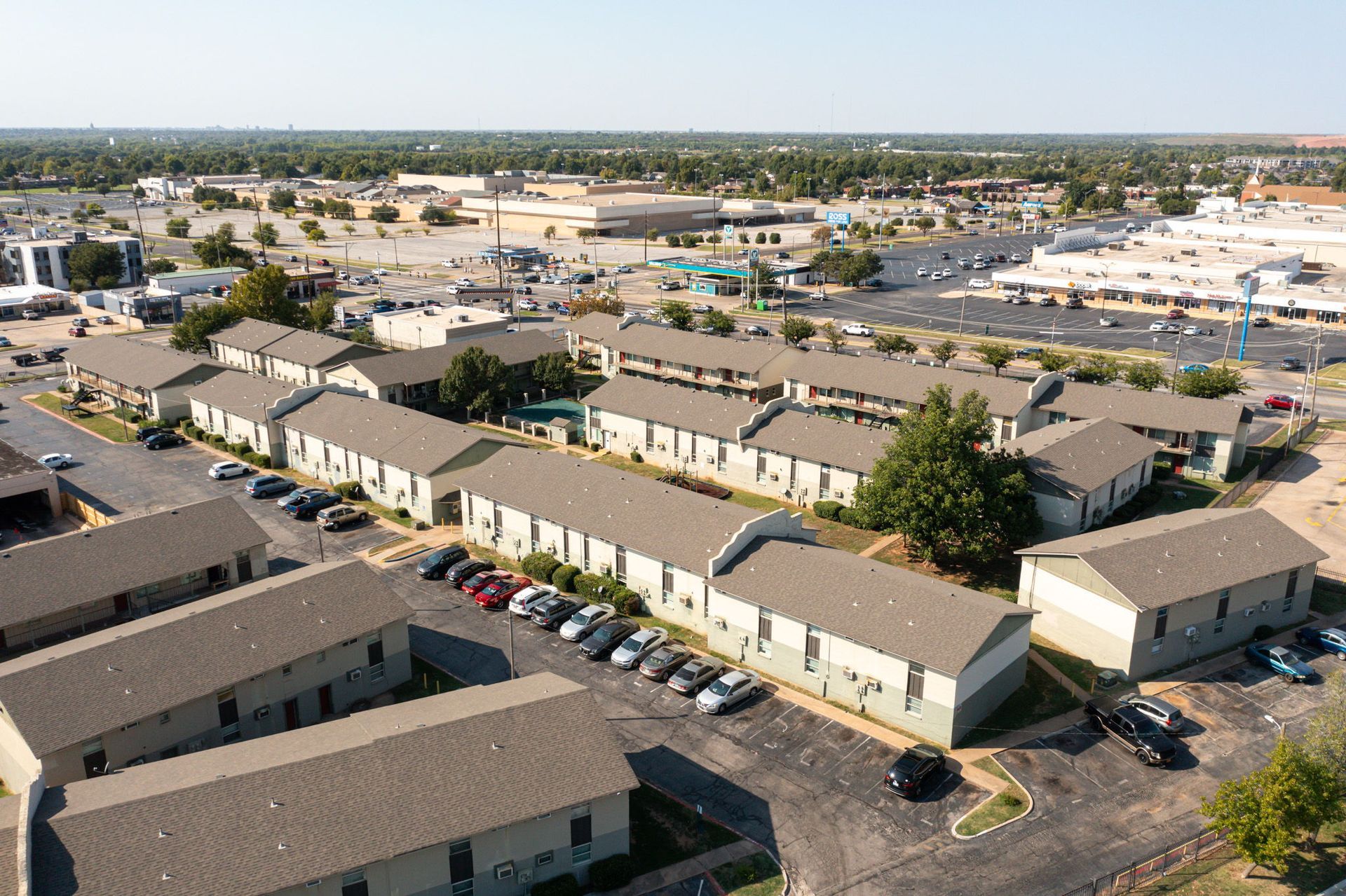 An aerial view of a row of apartment buildings in a city.