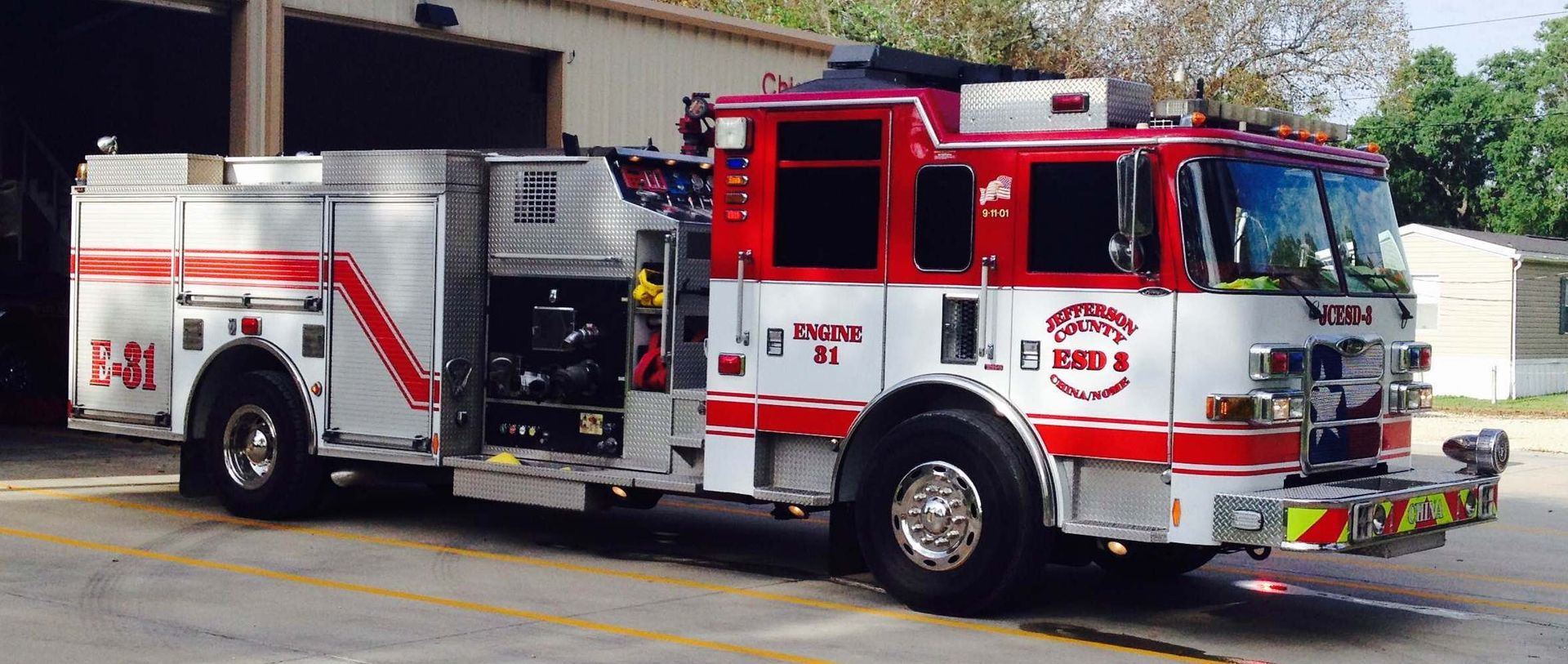 A red and white fire truck is parked in a parking lot