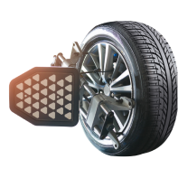Tire with wheel alignment tool attached, showing the tire's tread and a silver rim on a white background.