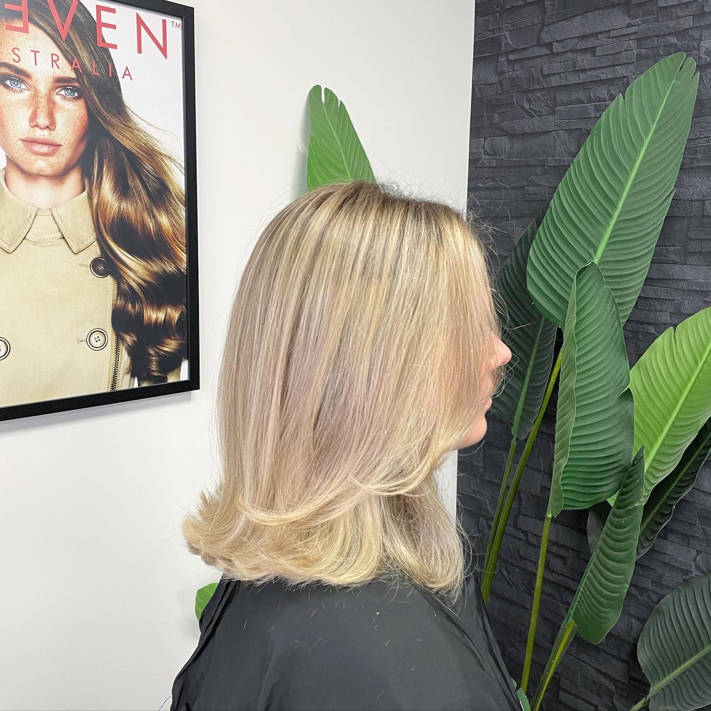 A Woman With Long Hair and Bangs is Wearing a Black Shirt — Fusion Hair In Woree, QLD
