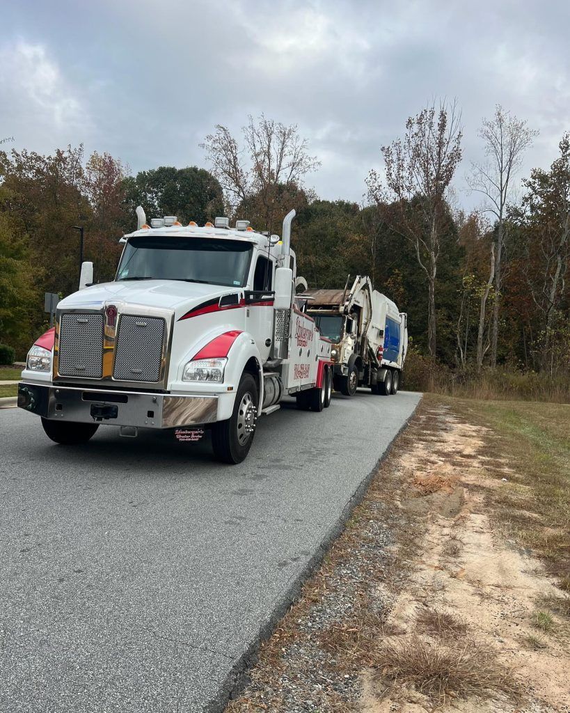 Two trucks are driving down a road next to each other.