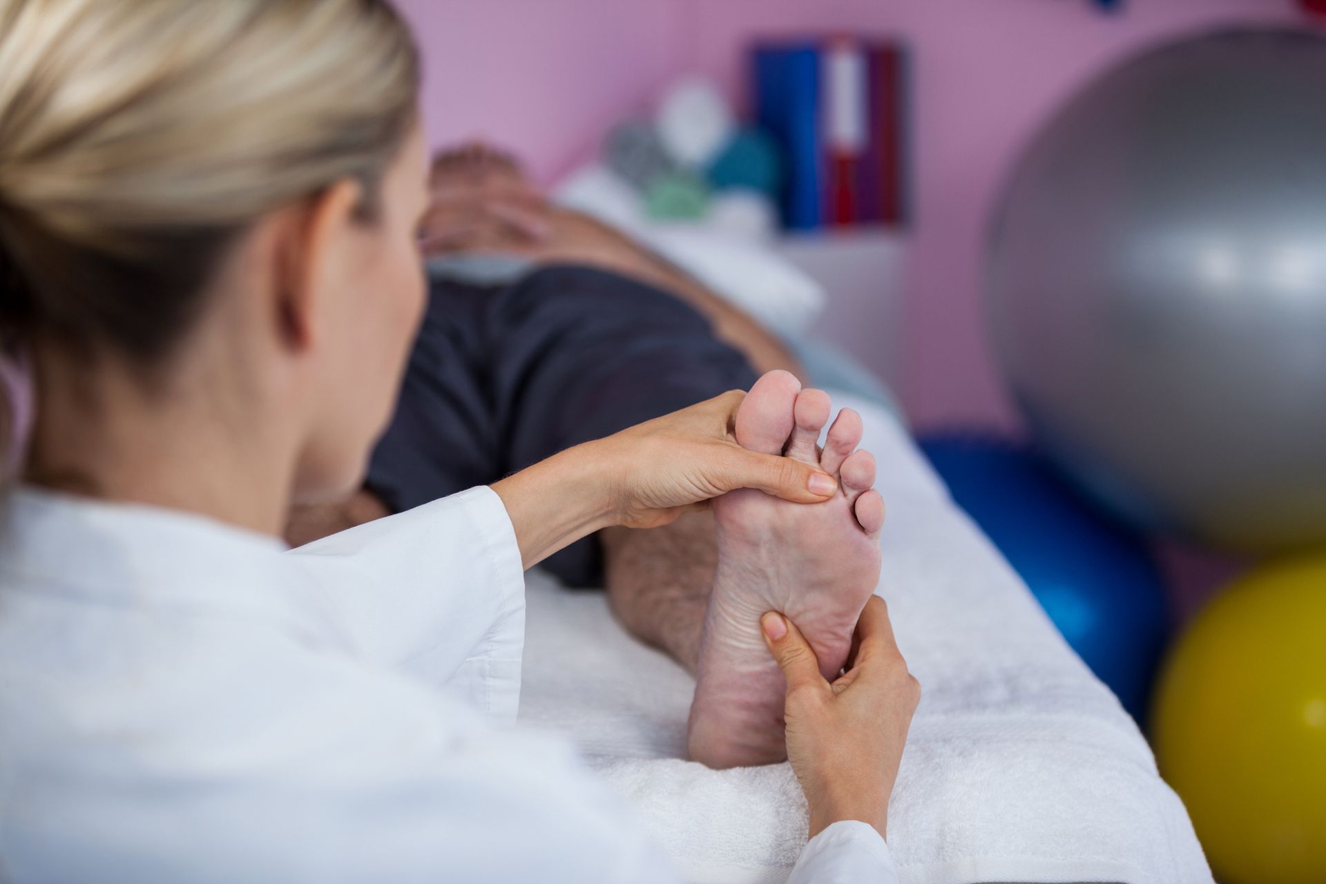 A Woman Is Giving A Foot Massage To A Man — Nicholson, PA — Optimal Whole Health & Nutrition