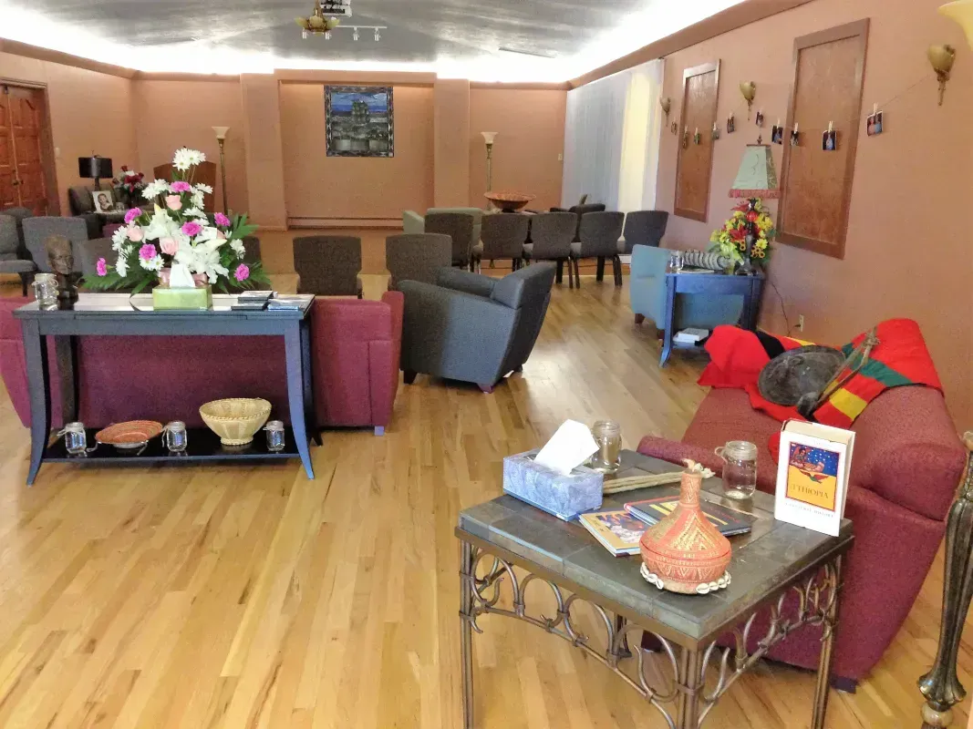 A fountain in a park with palm trees in the background